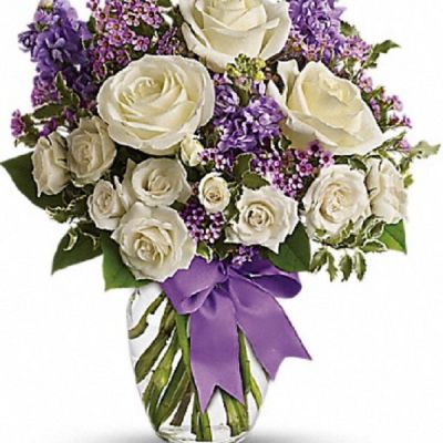 <div class="m-pdp-tabs-description">
<div id="mark-1" class="m-pdp-tabs-marketing-description">This magical bouquet will be at home in a cottage, a condo, a studio or an estate. It's so pretty it will be appreciated by all those lucky enough to receive it. Enchant someone today!</div>
</div>
<p id="arrngDescp">White roses and spray roses, lavender stock and waxflower, all perfectly arranged in a clear glass vase that's wrapped with purple ribbon.</p>
